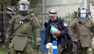 Uno de los ocupantes ilegales sale del inmueble , tras ser detenido por Carabineros